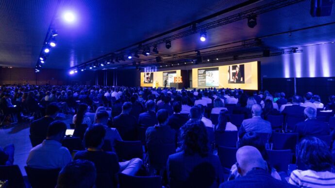 Clean tech professionals networking and collaborating at a clean energy industry conference.